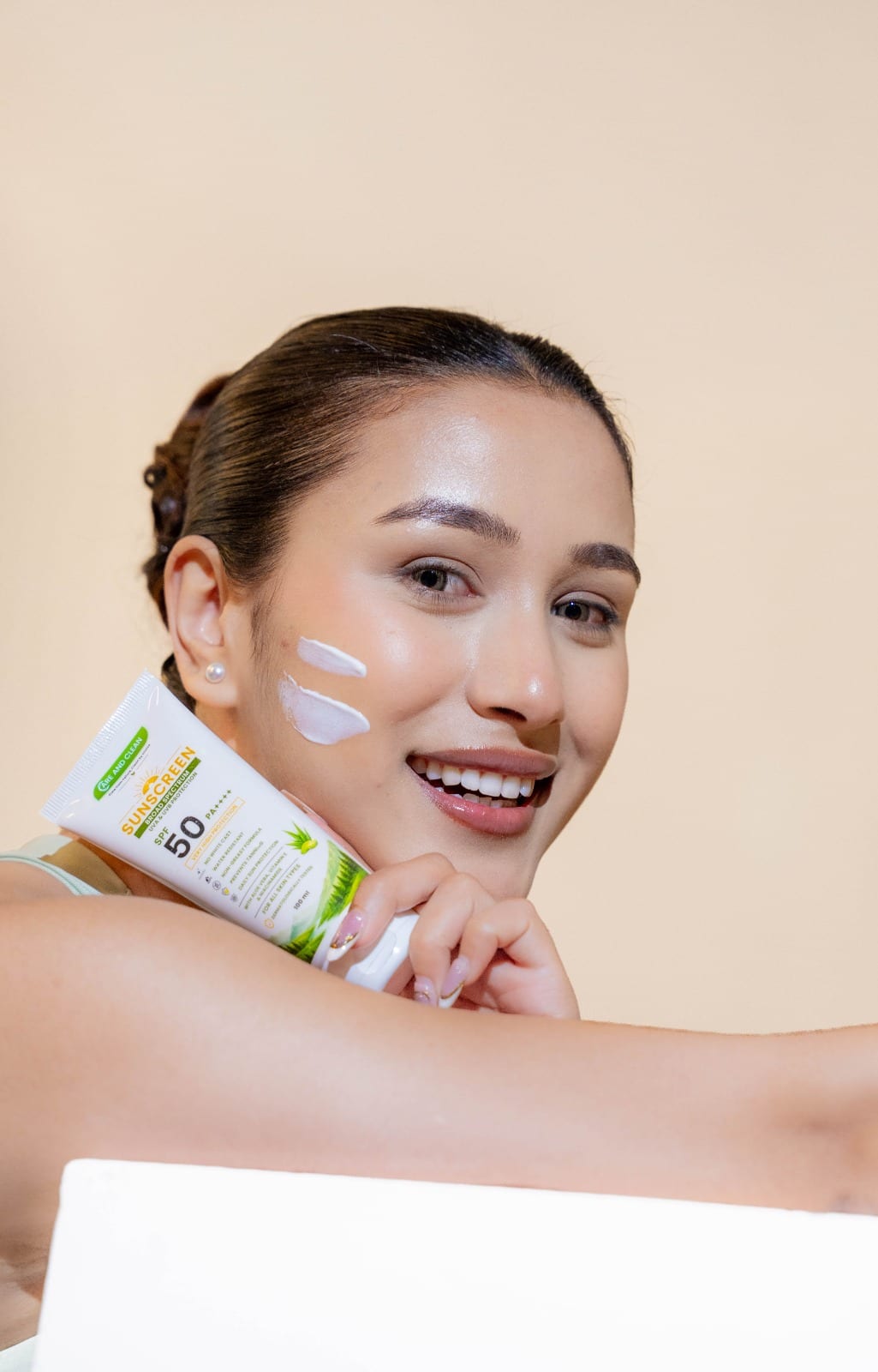 Customer applying Care and Clean sunscreen to her cheek